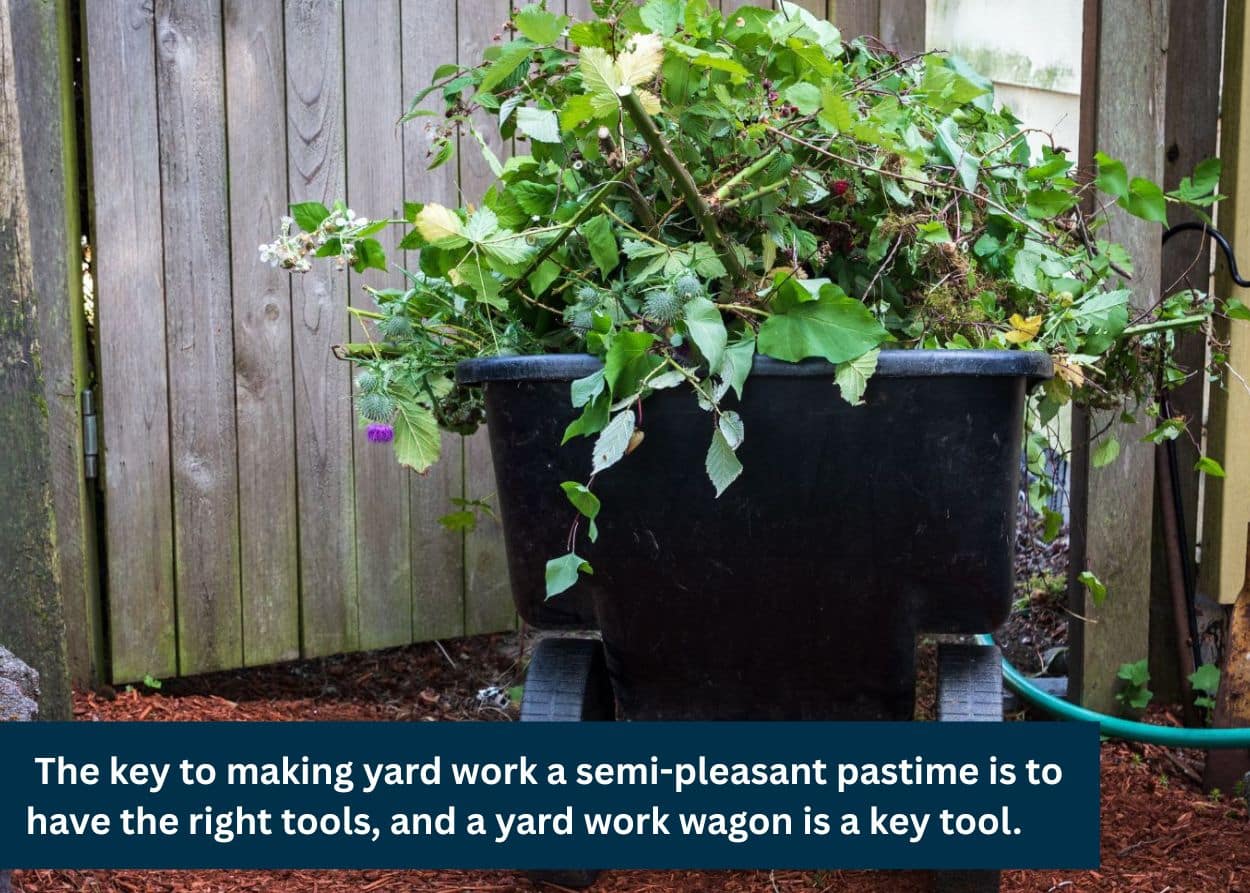 Plastic yard cart filled with garden debris and weeds near a backyard fence.